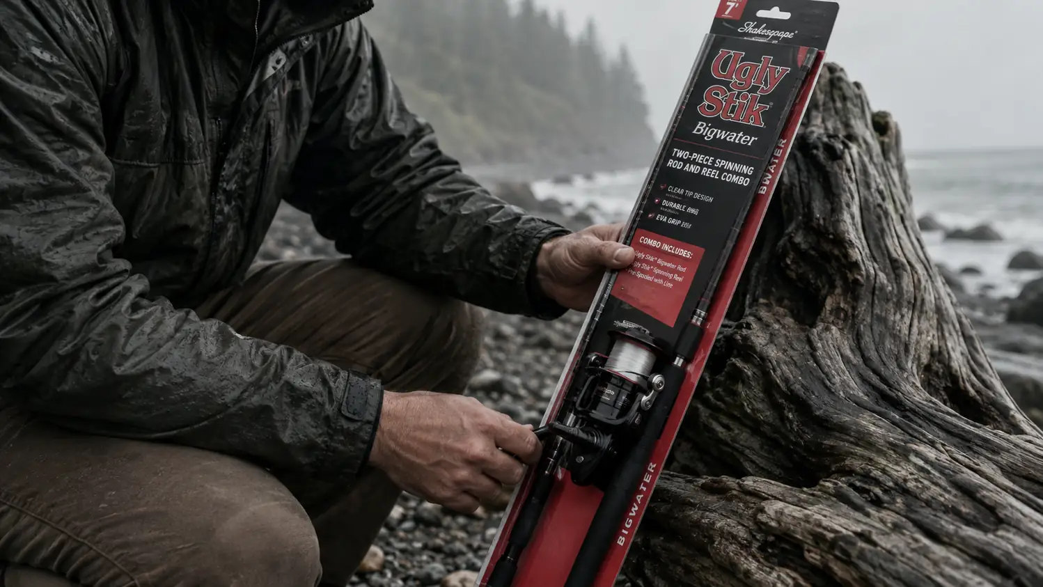 The Ugly Stik Bigwater spinning combo rigged and resting against a pile of gray driftwood on a wet beach